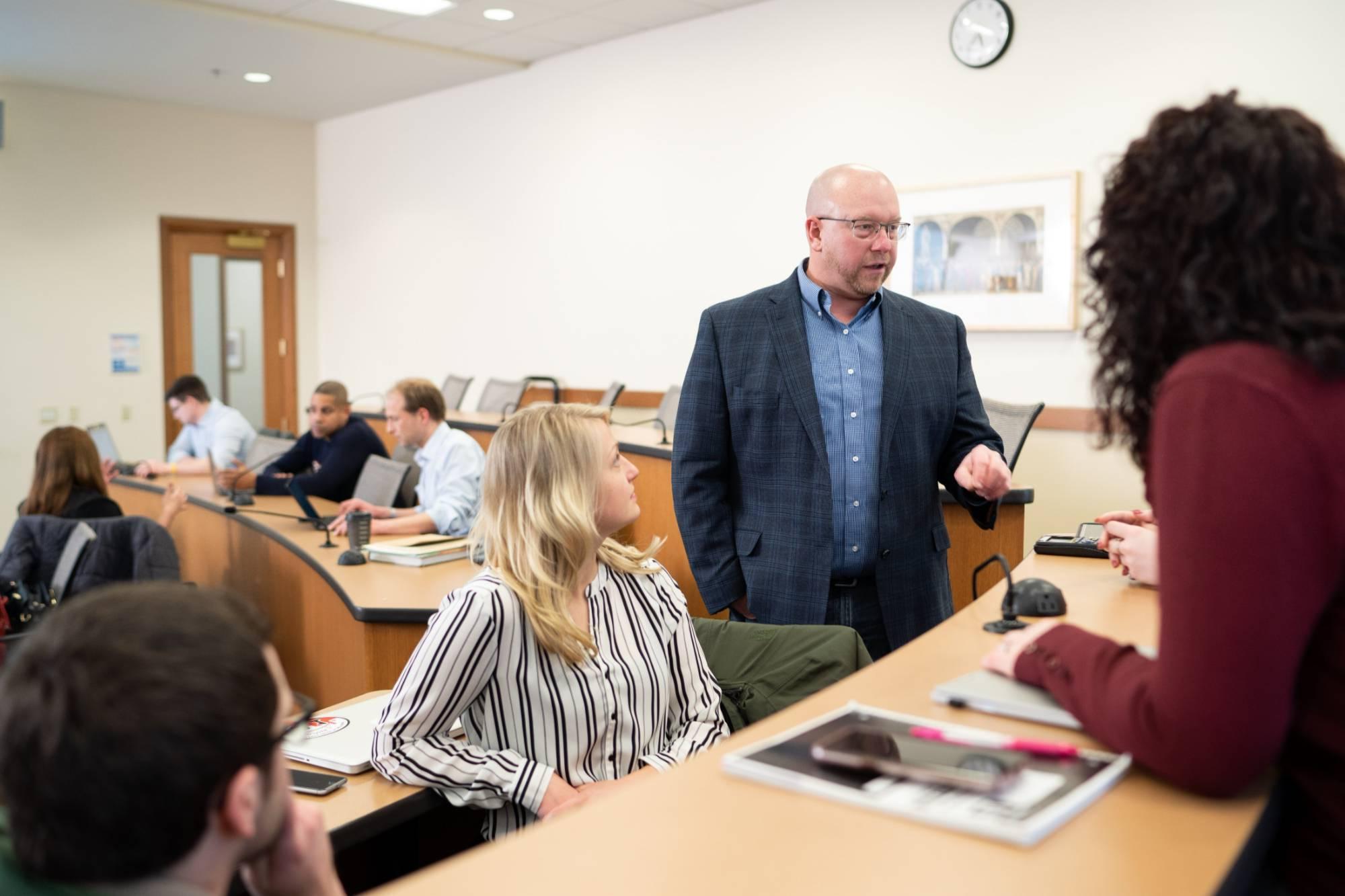 Professor Harper working with students in classroom